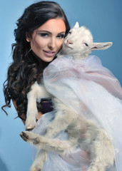 Cute brunette holding a little goat