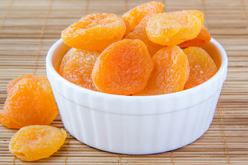 Dried apricots in a white ceramic bowl