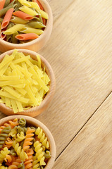 Raw tricolor pasta set on the wooden  table