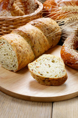 Group of bread loaves buns rolls on the wooden table