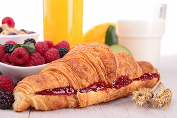 close up on croissant with fruits