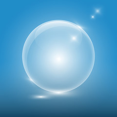 Transparent glass ball on blue background
