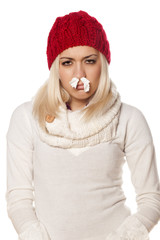 cold girl with paper stuffy nose on white background