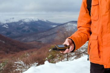 Backpacker holding in his hand GPS