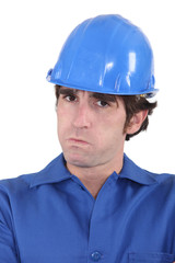 head-and-shoulders portrait of craftsman looking exasperated