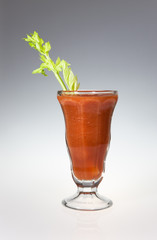 Veggie juice and celery stalk.