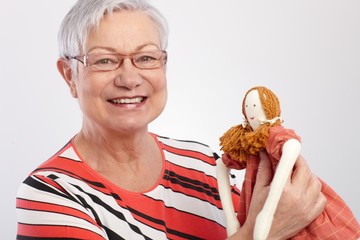 Granny holding rag doll smiling
