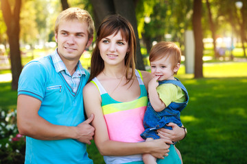portret baby with parents in a beautiful summer park