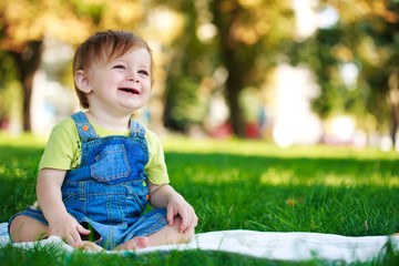 baby is playing on the green grass