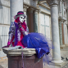 Person in Venetian costume attends Carnival of Venice.