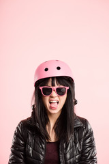 funny woman wearing Cycling Helmet portrait pink background real