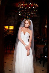 sexy  happy bride in white wedding dress in interior