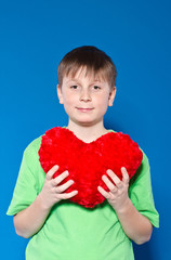 boy holding a heart on a blue background