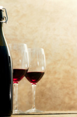 wine bottle with glasses of red wine out of flocus