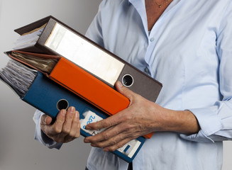 woman carrying binders