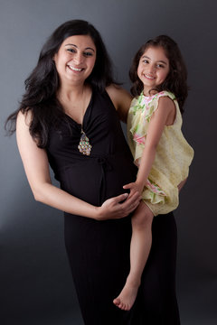 Pregnant East Indian Woman with her Daughter