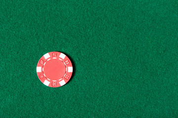 Top view of red poker chip on the green table - 48659546