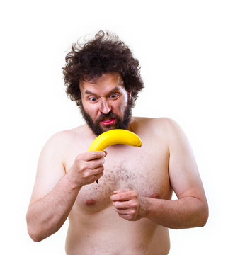 Wild man looking confused at a banana