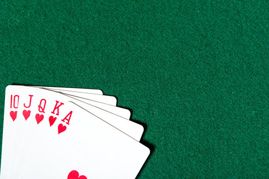 Royal Flush poker card sequence on a green table