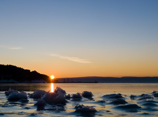 Sunset behind frozen fjord