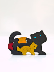 Colorful wooden cats puzzle isolated on white