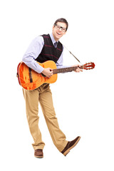 Full length portrait of a young male playing a guitar