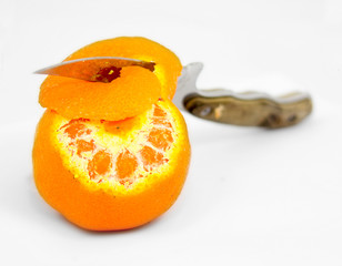 Partually peeled tangerine on white background