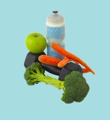 Dumbells made of broccoli with water bottle, carrots and green a