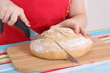 female hands cutting bread