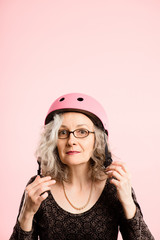 funny woman wearing Cycling Helmet portrait pink background real