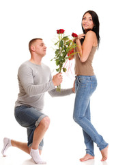 Attractive young couple gift rose in hand isolated