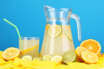 Citrus lemonade in glass and pitcher of citrus around