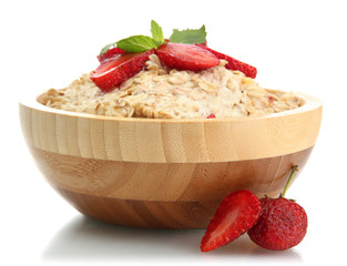 tasty oatmeal with strawberries, isolated on white