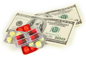 Pills and money isolated on white