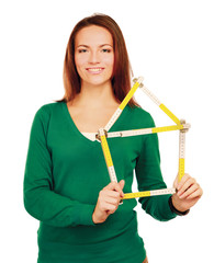 Woman holding a ruler in the form of a house