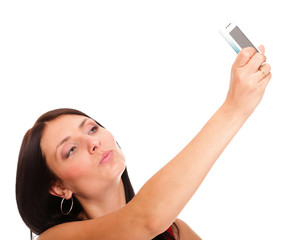 Naklejka premium Young woman takes photos using her mobile phone