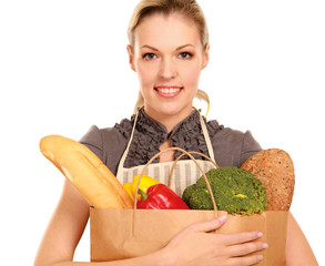 Woman in apron holding grocery bag