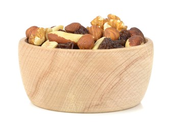 A wooden bowl of mixed fruit and nuts on white background