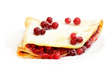 Pancake with raspberry jam and cowberry berries