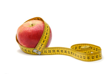 Diet concept. Aple with measuring tape on white