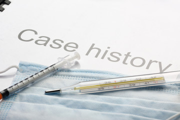 Obraz premium Case history, mask, syringe and thermometer
