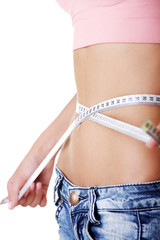 Young woman measuring her waist