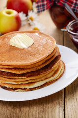 Delicious pancakes with butter and jam on the wooden kitchen  ta