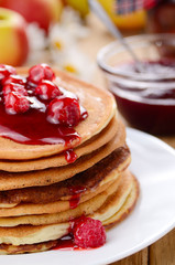 Delicious pancakes with raspberries on the wooden kitchen  tabl