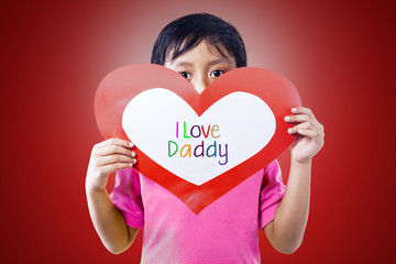 Boy give love card to dad