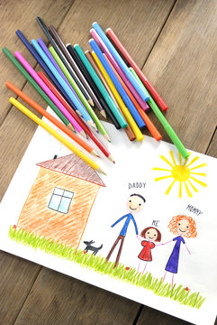 kids drawing happy family near their house