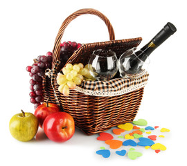 Picnic basket with fruits and bottle of wine isolated on white