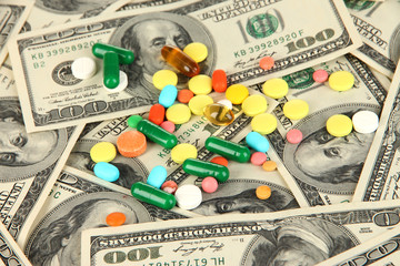 Pills and money close-up background