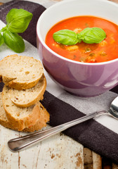 Tasty fresh tomato soup basil and bread