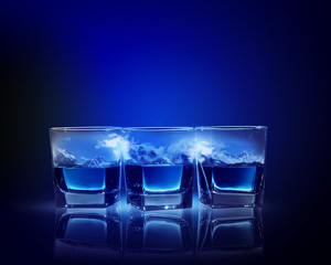 Three glasses of blue liquid